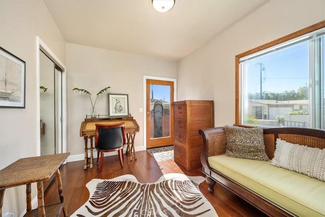 sitting room featuring baseboards and wood finished floors