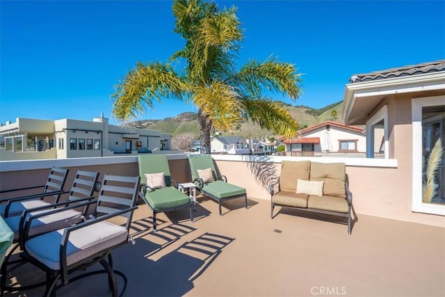 view of patio / terrace featuring a mountain view and a balcony