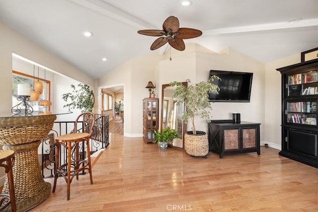 sitting room featuring vaulted ceiling with beams, light wood finished floors, an upstairs landing, and baseboards