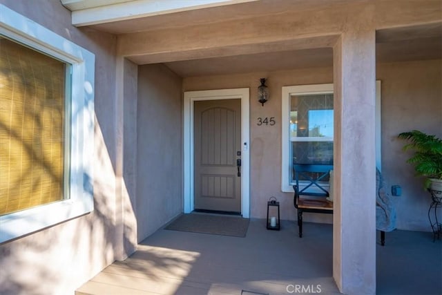 view of exterior entry featuring stucco siding