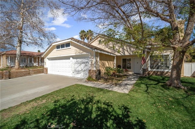 view of front of house featuring brick siding, an attached garage, a front yard, fence, and driveway