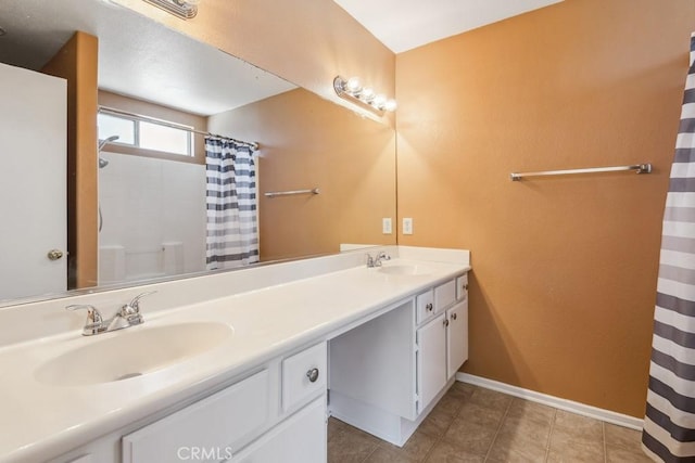 full bath featuring double vanity, curtained shower, a sink, and tile patterned floors