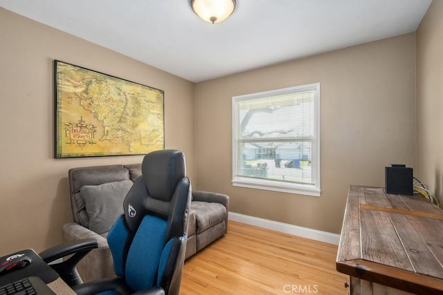 office area featuring light wood-style floors and baseboards