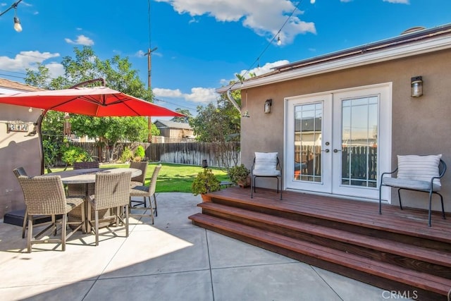 view of patio / terrace featuring fence, outdoor dining area, and french doors