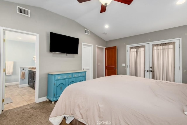 bedroom with vaulted ceiling, french doors, light carpet, and visible vents