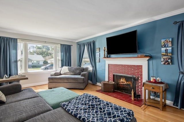 living area with crown molding, a fireplace, and wood finished floors