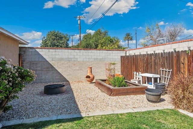 view of yard with a garden and a fenced backyard