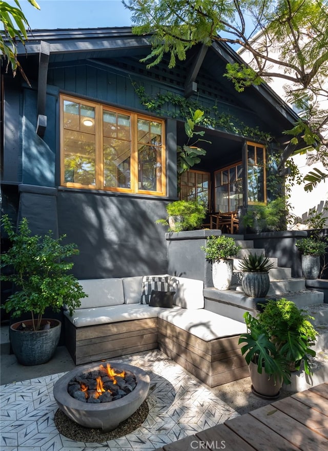 exterior space featuring a fire pit and board and batten siding