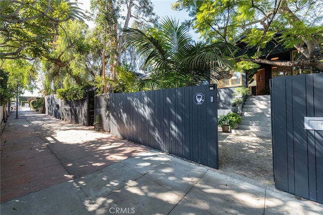 view of gate with a fenced front yard