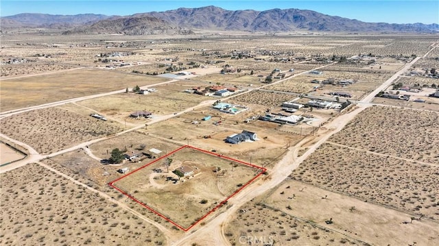 bird's eye view featuring a rural view, a mountain view, and view of desert