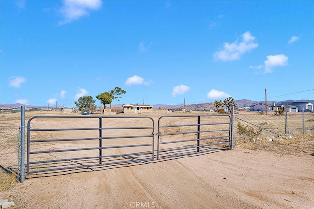 view of gate with a rural view