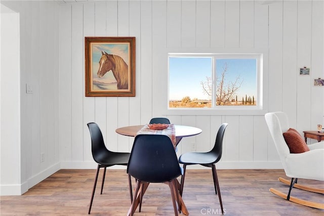 dining area featuring wood finished floors and baseboards