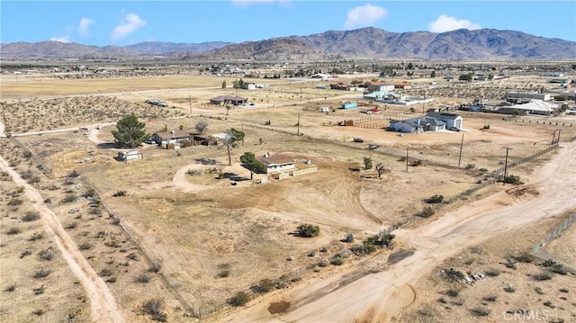 drone / aerial view with a mountain view, a desert view, and a rural view