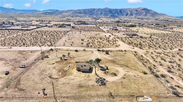 birds eye view of property featuring a mountain view, a desert view, and a rural view