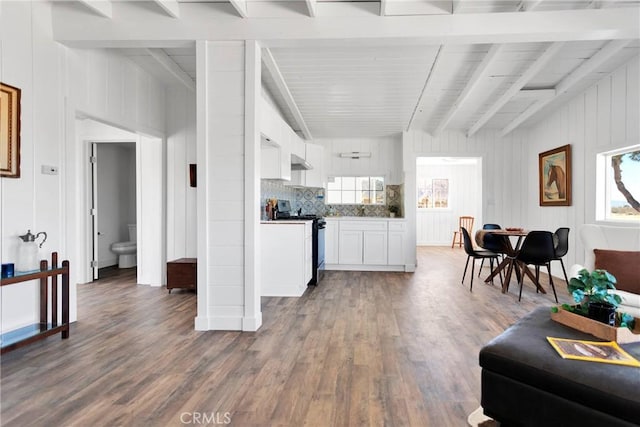 kitchen featuring white cabinets, beamed ceiling, electric range, and wood finished floors