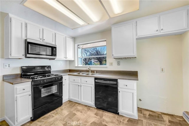 kitchen featuring black appliances, a sink, and white cabinets