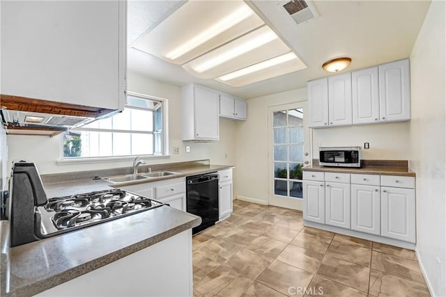 kitchen featuring visible vents, dishwasher, range with gas cooktop, stainless steel microwave, and a sink