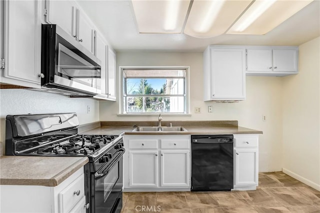 kitchen featuring black appliances, a sink, and white cabinets