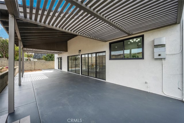 view of patio featuring fence and a pergola