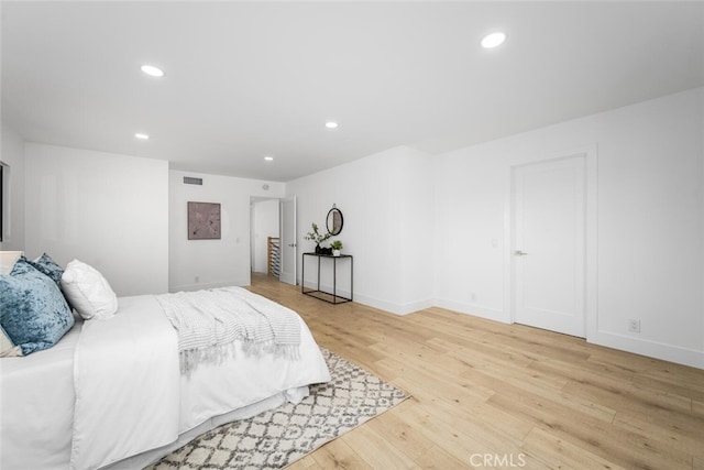 bedroom with light wood-style flooring, visible vents, baseboards, and recessed lighting