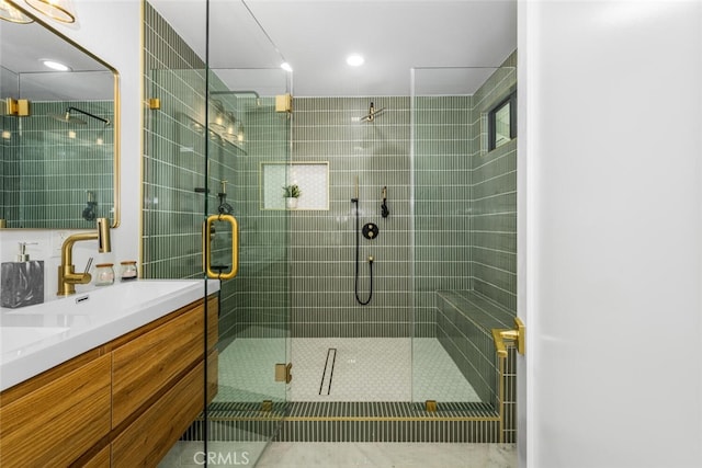 bathroom featuring double vanity and a shower stall