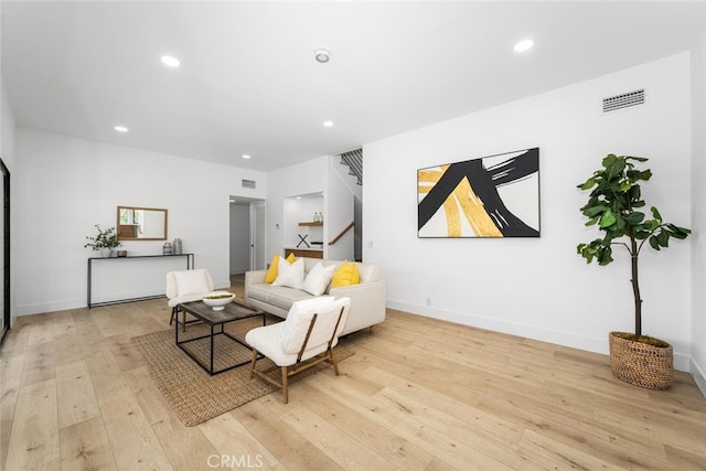 living room featuring stairway, recessed lighting, visible vents, and light wood-style flooring