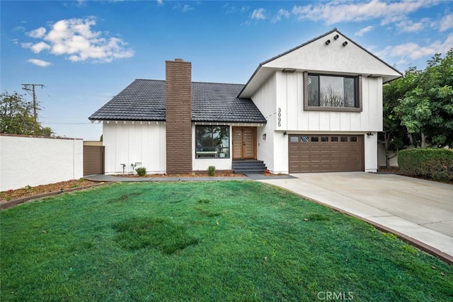 view of front of home featuring an attached garage, a tile roof, concrete driveway, a front lawn, and a chimney