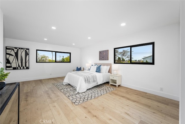 bedroom with recessed lighting, baseboards, and hardwood / wood-style floors