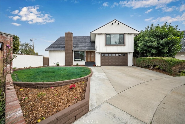 view of front of home featuring driveway, a chimney, an attached garage, fence, and board and batten siding