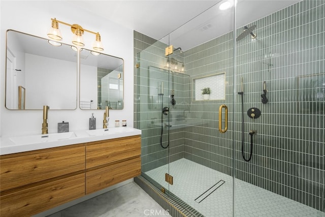 bathroom with double vanity, a stall shower, and a sink