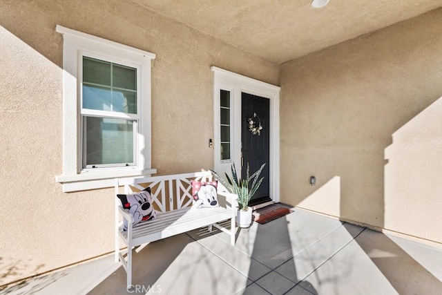 doorway to property with stucco siding