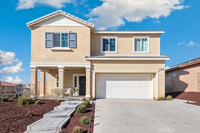 view of front facade with driveway, an attached garage, and stucco siding