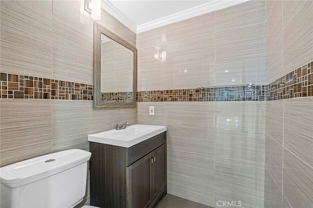 half bath featuring crown molding, tile walls, and vanity