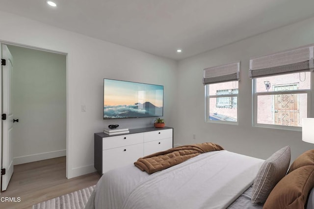 bedroom with light wood finished floors, baseboards, and recessed lighting