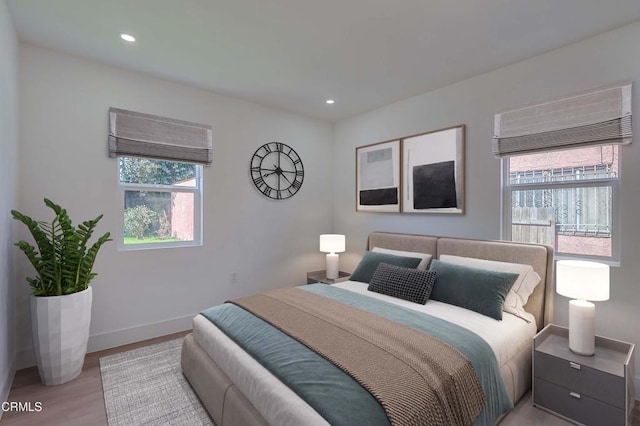 bedroom featuring baseboards, wood finished floors, and recessed lighting