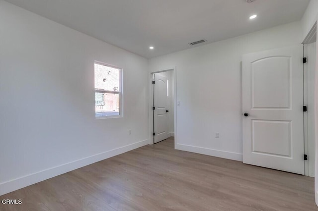 unfurnished bedroom featuring light wood-style floors, recessed lighting, visible vents, and baseboards