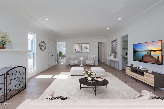 living room with wood finished floors and recessed lighting