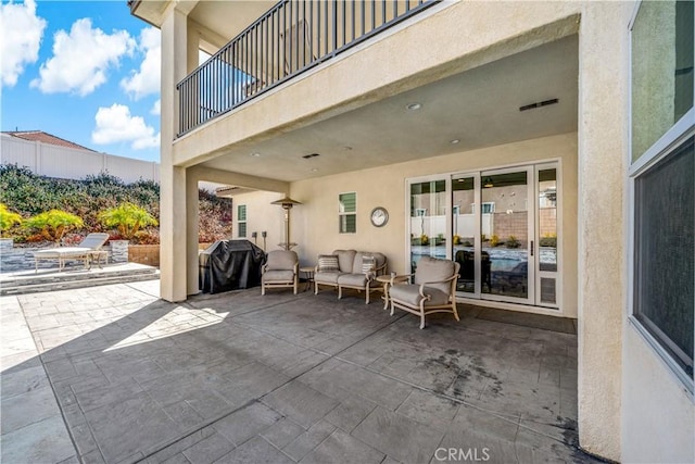 view of patio / terrace with an outdoor living space, a balcony, and area for grilling