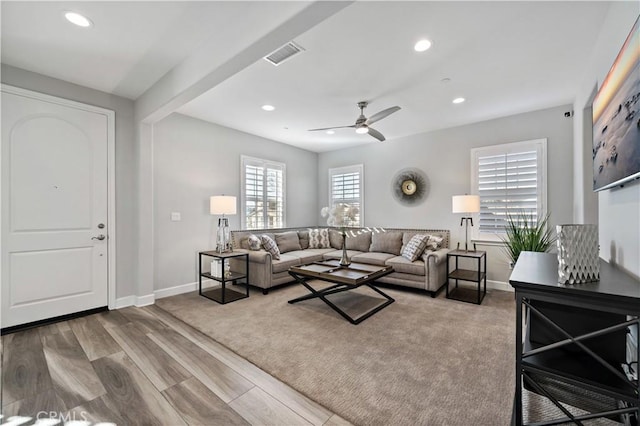 living area featuring recessed lighting, visible vents, baseboards, and wood finished floors