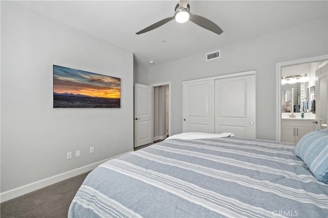 bedroom with baseboards, visible vents, connected bathroom, carpet floors, and a closet