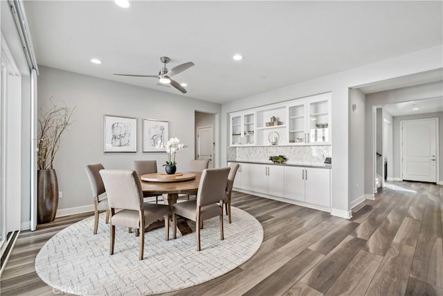 dining space with recessed lighting, ceiling fan, baseboards, and wood finished floors