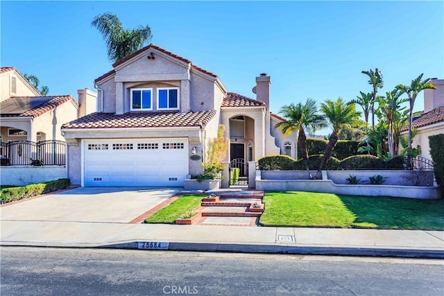 mediterranean / spanish home featuring a garage, concrete driveway, a tiled roof, and stucco siding