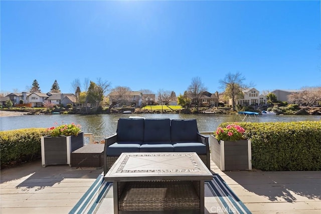 exterior space featuring a residential view, a water view, and an outdoor living space