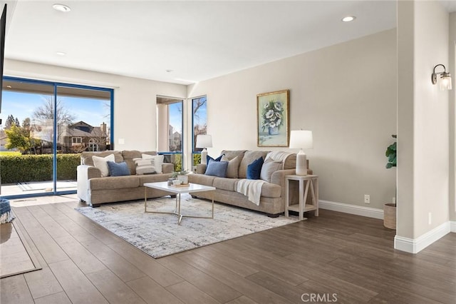 living area featuring recessed lighting, baseboards, and wood finished floors