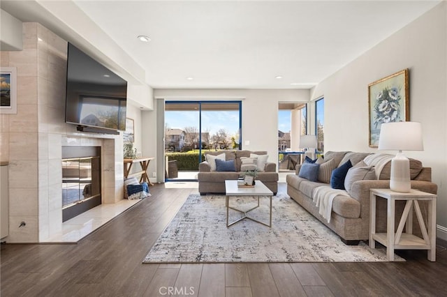 living room featuring a premium fireplace and wood finished floors