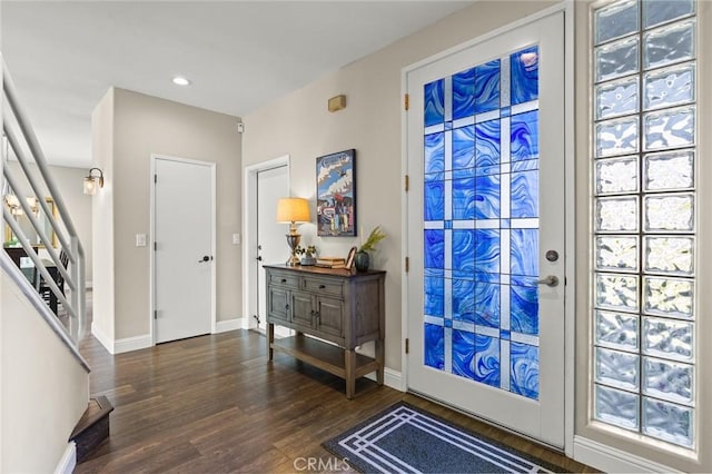 entryway with recessed lighting, stairway, baseboards, and wood finished floors