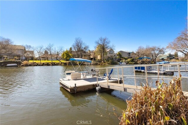 dock area with a residential view and a water view