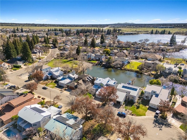 drone / aerial view featuring a residential view and a water view