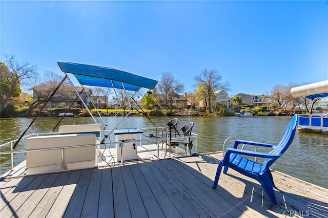 view of dock featuring a residential view and a water view