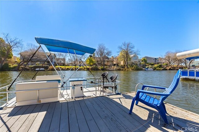 dock area with a residential view and a water view